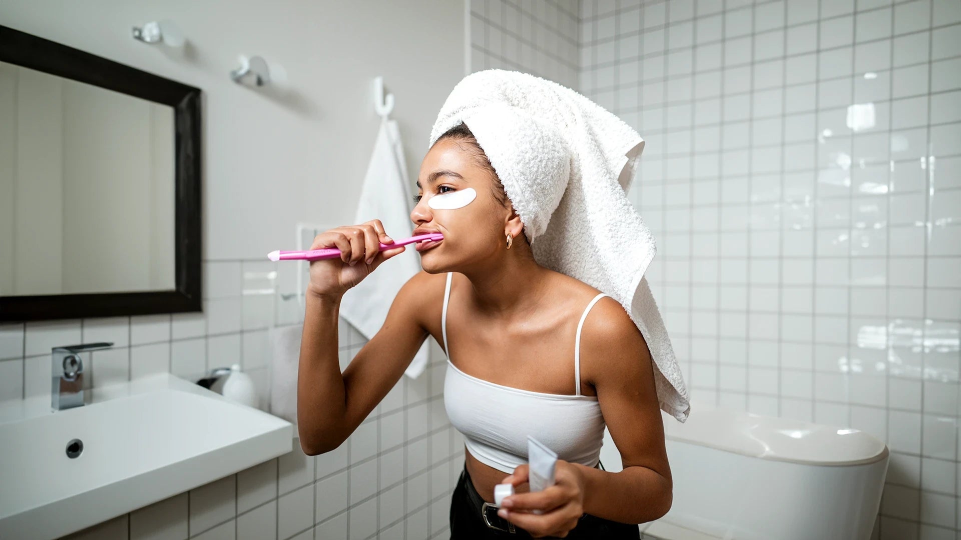 Young woman brushing her teeth in the bathroom